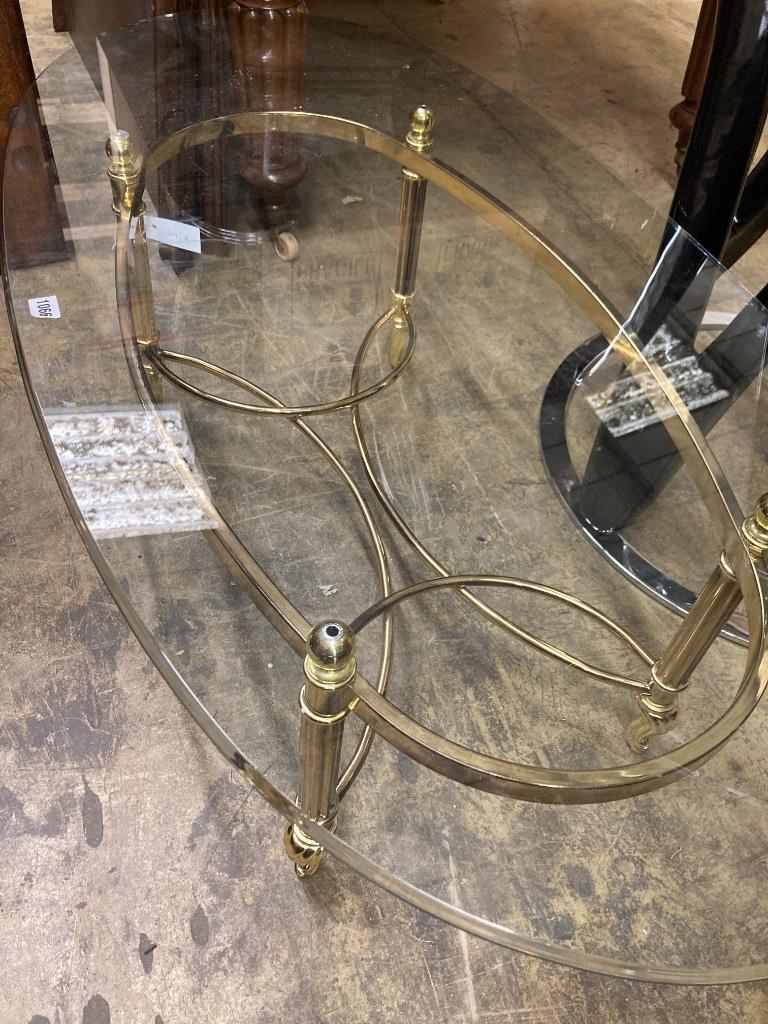 A contemporary glass topped brass oval coffee table, length 126cm, width 66cm, height 41cm
